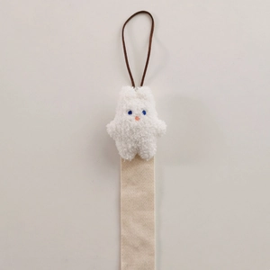 Detail of white plush rabbit hair clip organizer with beige ribbon and hanging cord