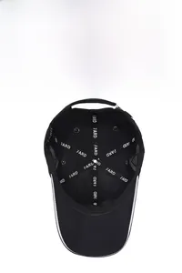 Detail view of the breathable mesh lining and interior tape of the black baseball cap