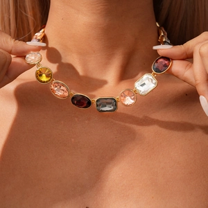Close-up of luxury gold-plated necklace with vibrant multi-color crystal gemstones
