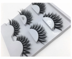 Macro shot of 5 pairs of T07 dense faux mink eyelashes in a white plastic tray