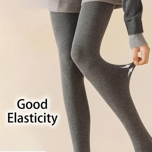Close-up showing the high elasticity of dark gray cotton ribbed leggings through stretching