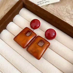 Vintage acrylic square pendant earrings with red studs and amber marble texture