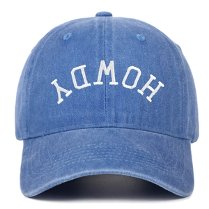 Close-up of white inverted HOWDY embroidery on blue washed cotton baseball cap