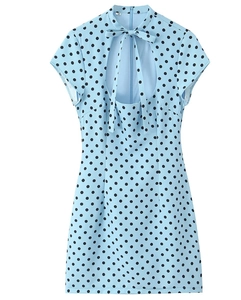 Detail of light blue polka dot dress featuring a bow tie neckline and teardrop cutout