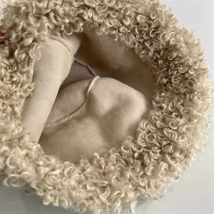 Detail of curly faux shearling texture and soft suede lining on the winter bucket hat
