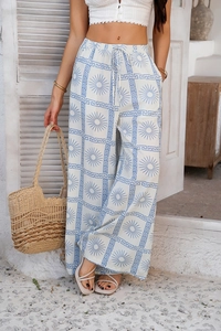 Pantalon bohème blanc à jambes larges avec motif soleil bleu et cordon à la taille