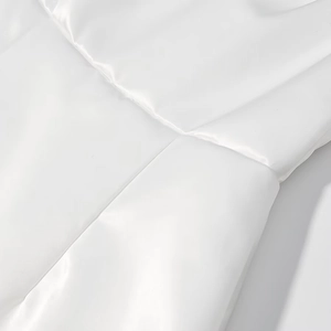Close-up of white satin fabric texture and premium seam detail of the elegant long dress