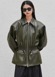 Detailed view of an olive green faux leather jacket with zip closure and elastic waist