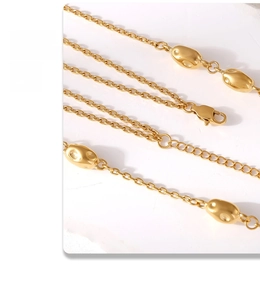 Detail of gold double-layer necklace showing lobster clasp and polished organic beads