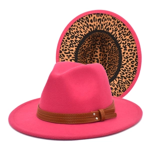 Close-up of fuchsia fedora hat featuring leopard print lining and brown leather rivet band