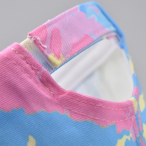 Detail of adjustable velcro strap on tri-color gradient twill baseball cap with stitching