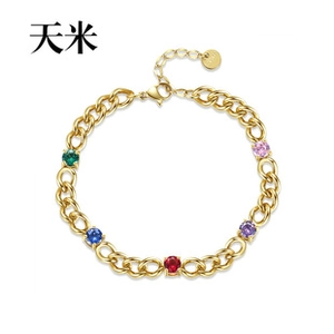 Detailed view of gold chain bracelet featuring five vibrant round-cut colorful zircons