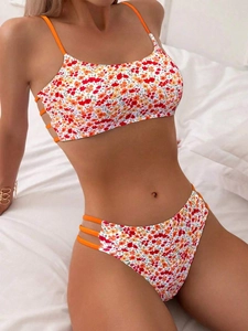 Detail view of floral print bikini set with bright orange side tie and cutout straps