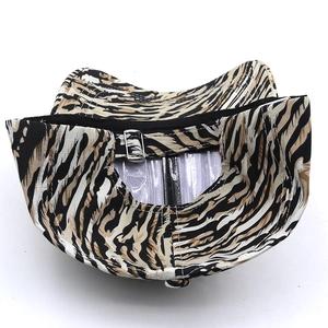 Detail of adjustable metal buckle and black sweatband on tiger print baseball cap