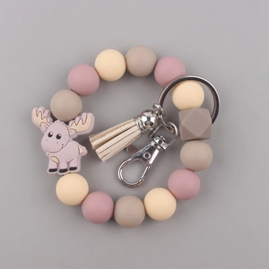 Macro view of silicone beaded bracelet keychain with moose charm and decorative tassel
