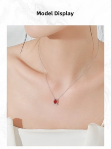 Detailed view of an S925 silver necklace featuring an oval red ruby and white diamonds on a model