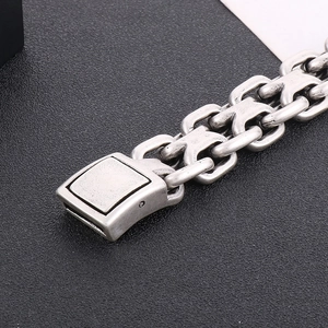 Macro shot of the vintage clasp and interlocking chain on this steel curb bracelet