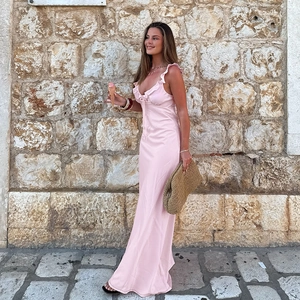 Pink satin slip dress with deep V-neck ruffle detail for elegant summer vacation style