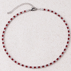 Detail of tennis chain with alternating red and white crystals and lobster clasp