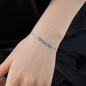 Detail of S925 sterling silver evil eye bracelet with blue and white crystals