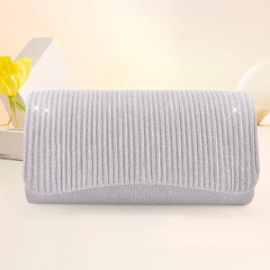 Detailed close-up of a silver evening clutch bag featuring elegant pleated glitter fabric