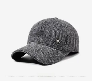 Detail view of winter baseball cap with grey tweed texture and metal logo badge