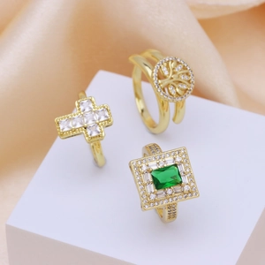 Three 18k gold plated open rings featuring tree of life, cross, and green zircon stones