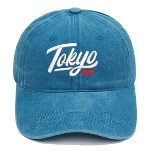 Detail of Tokyo embroidery and stitching on a washed blue cotton baseball cap
