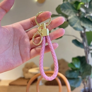 Pink woven leather keychain with gold metal ring and clasp, stylish car accessory gift