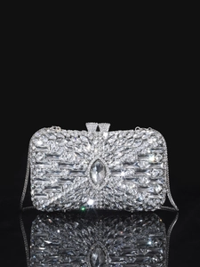 Close-up of sparkling silver rhinestone evening bag with elegant chain and metallic reflections