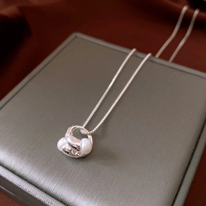 Detailed macro view of 18k gold plated double pearl pendant on a fine box chain