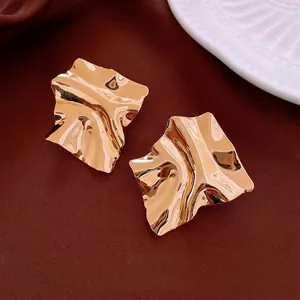 Minimalist irregular square gold plated earrings with a wrinkled metallic texture finish