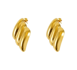 Detailed close-up of chunky gold wave earrings with high-polish rippled texture