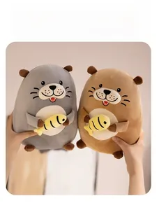 Detail of plush otter doll holding a yellow fish with soft texture and expressive face