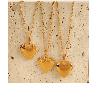 Detailed macro view of three vintage heart locket pendants in gold plating