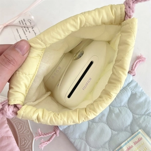 Internal view of a quilted drawstring pouch showing storage capacity for Instax camera
