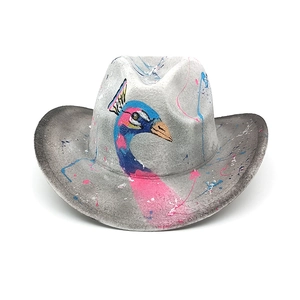 Detail of gray felt cowboy hat featuring artistic peacock and colorful graffiti paint