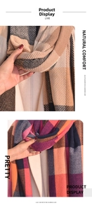 Detail of plaid imitation cashmere scarves with soft texture and classic tassels