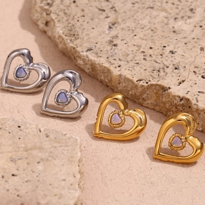 Detail of 18K gold and silver double layer hollow heart earrings with opal stone