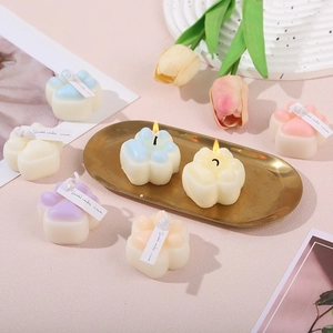 Cat paw shaped scented candles in macaron colors on a gold tray for home decor