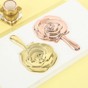 Rose shaped handheld mirrors in rose gold and gold finish with carved floral details