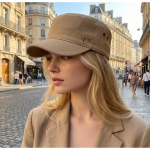 Detail of khaki military flat cap with metal logo and premium twill cotton fabric