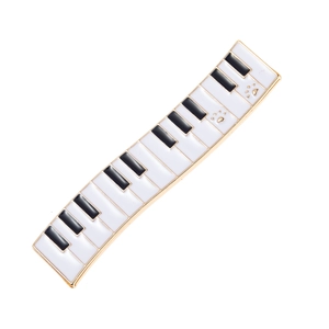 Elegant piano key hair clip with white and black enamel and gold cat paw accents