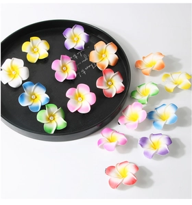 Detailed macro view of colorful Frangipani hair clips with faux pearls for beach vacations