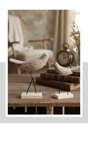 Close-up of vintage wooden bird figurines with retro textures and metal stands on wooden bases