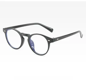 Close-up of retro black round frame glasses featuring silver rivet accents on the hinges