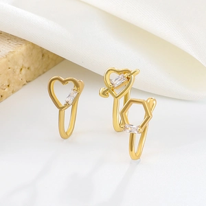 Close-up of three gold U-shaped non-piercing nose clips with zircon hearts and arrows