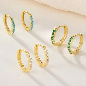 Macro detail of S925 sterling silver gold plated hoop earrings with colorful zircon stones