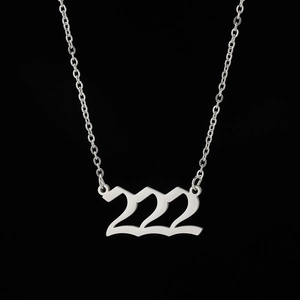 Detailed macro view of silver stainless steel necklace with numeric 222 pendant