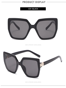 Detail of rhinestone embellishment on oversized cat-eye sunglasses with black frames